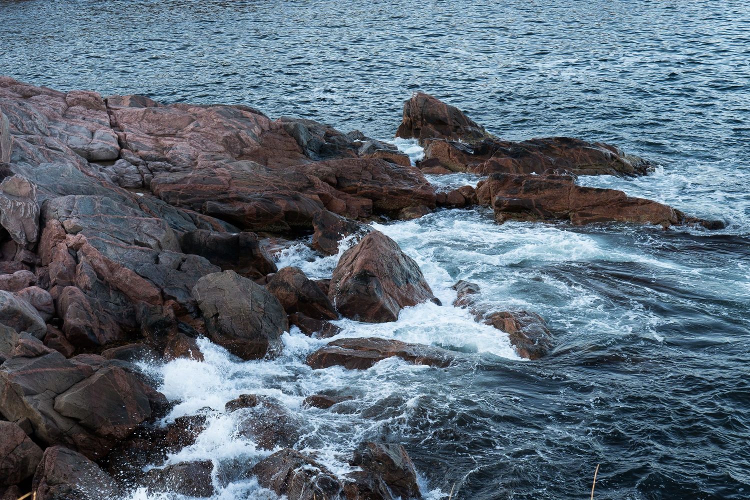 Blue sea red rocks