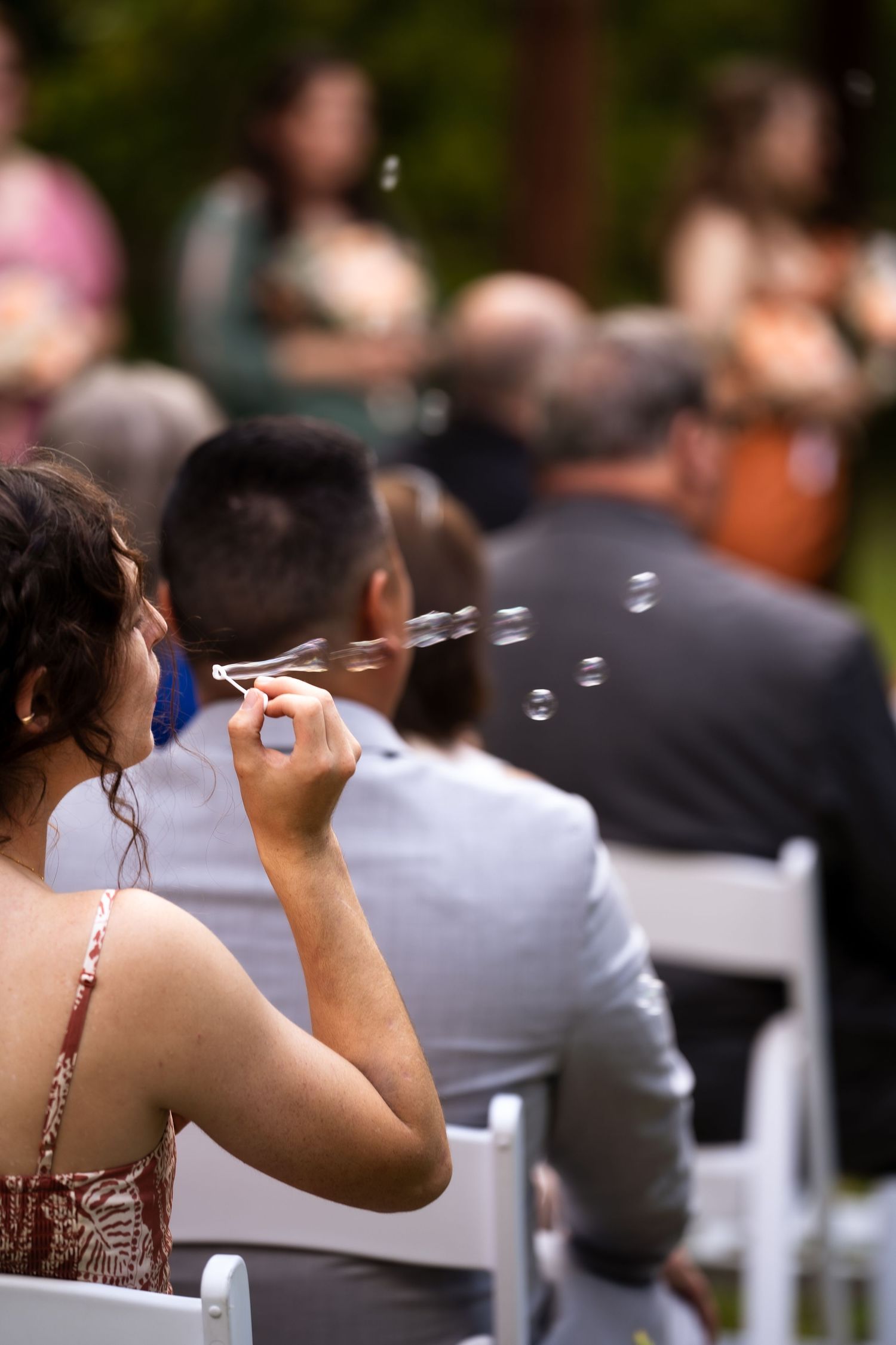 wedding guest blows bubbles