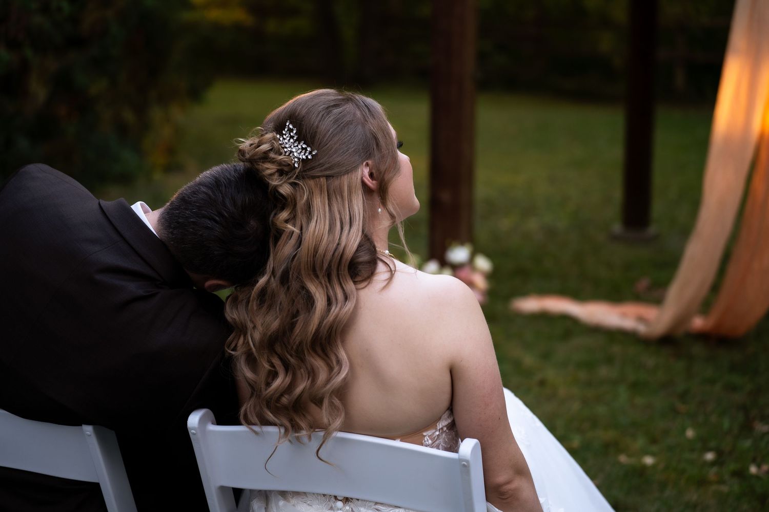 groom leans on the bride