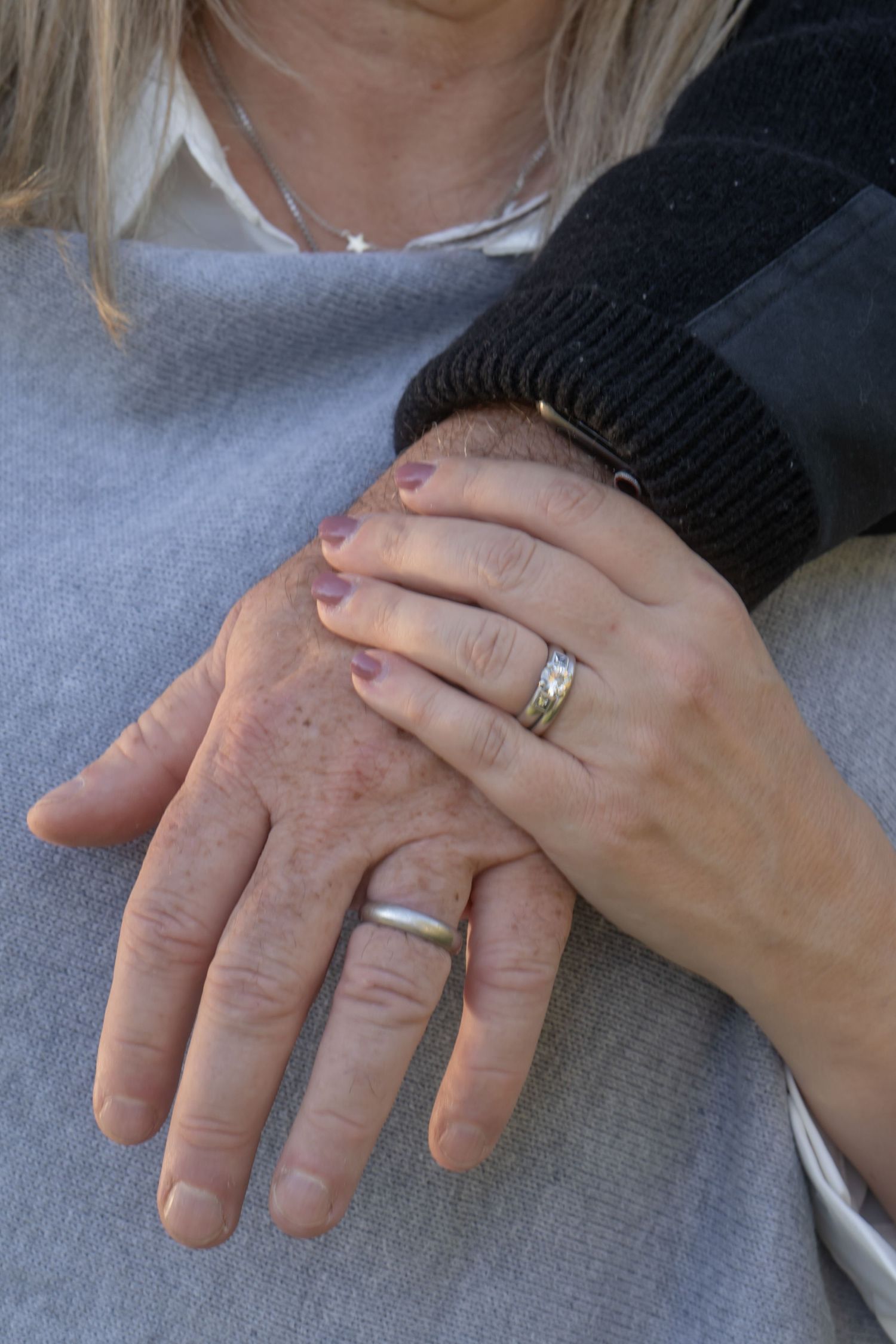 Close-up shots of hands with wedding rings showing gentle, loving touches.
