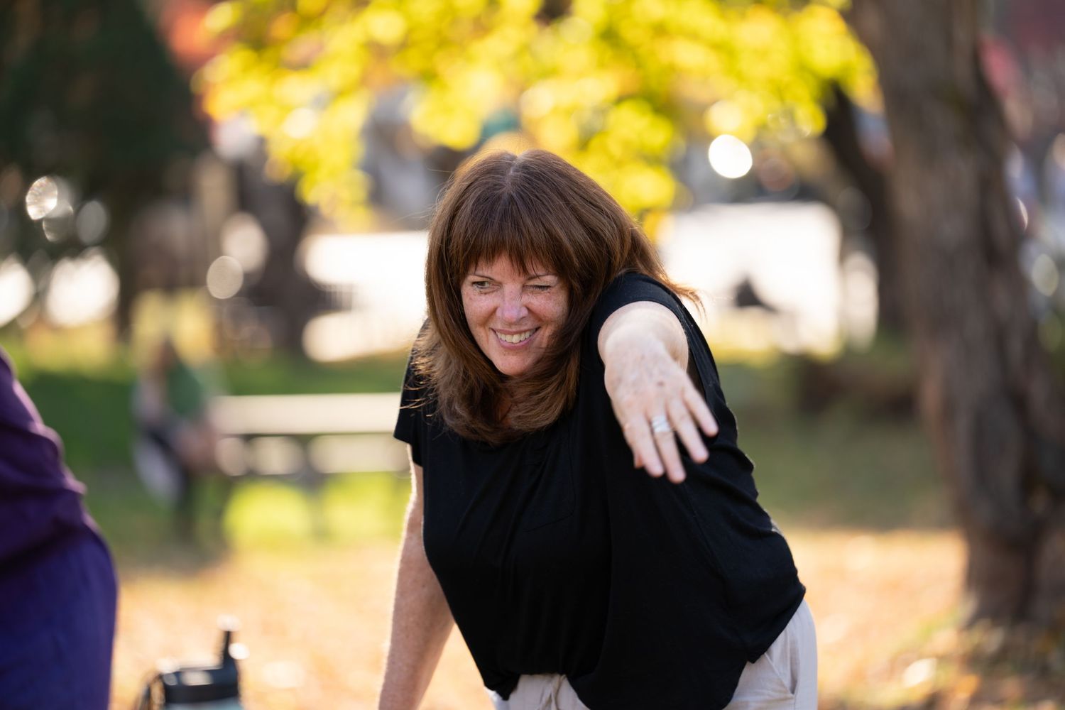 A sequence of joyful outdoor photos showing someone in black clothing against autumn trees and sunlit backgrounds.