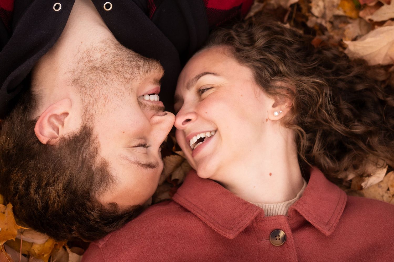 man and woman touch noses while laughing