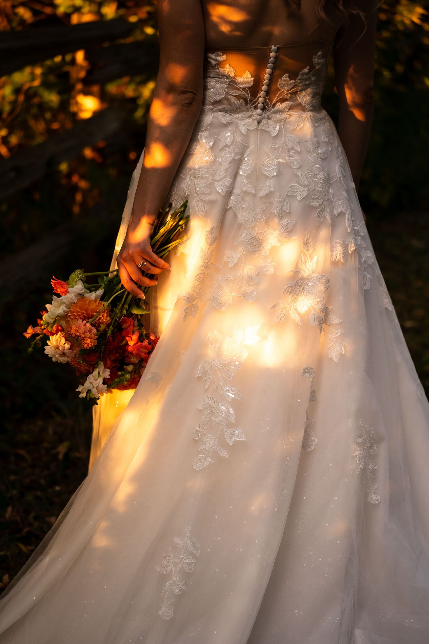 bridal gown in sunlight with bouquet