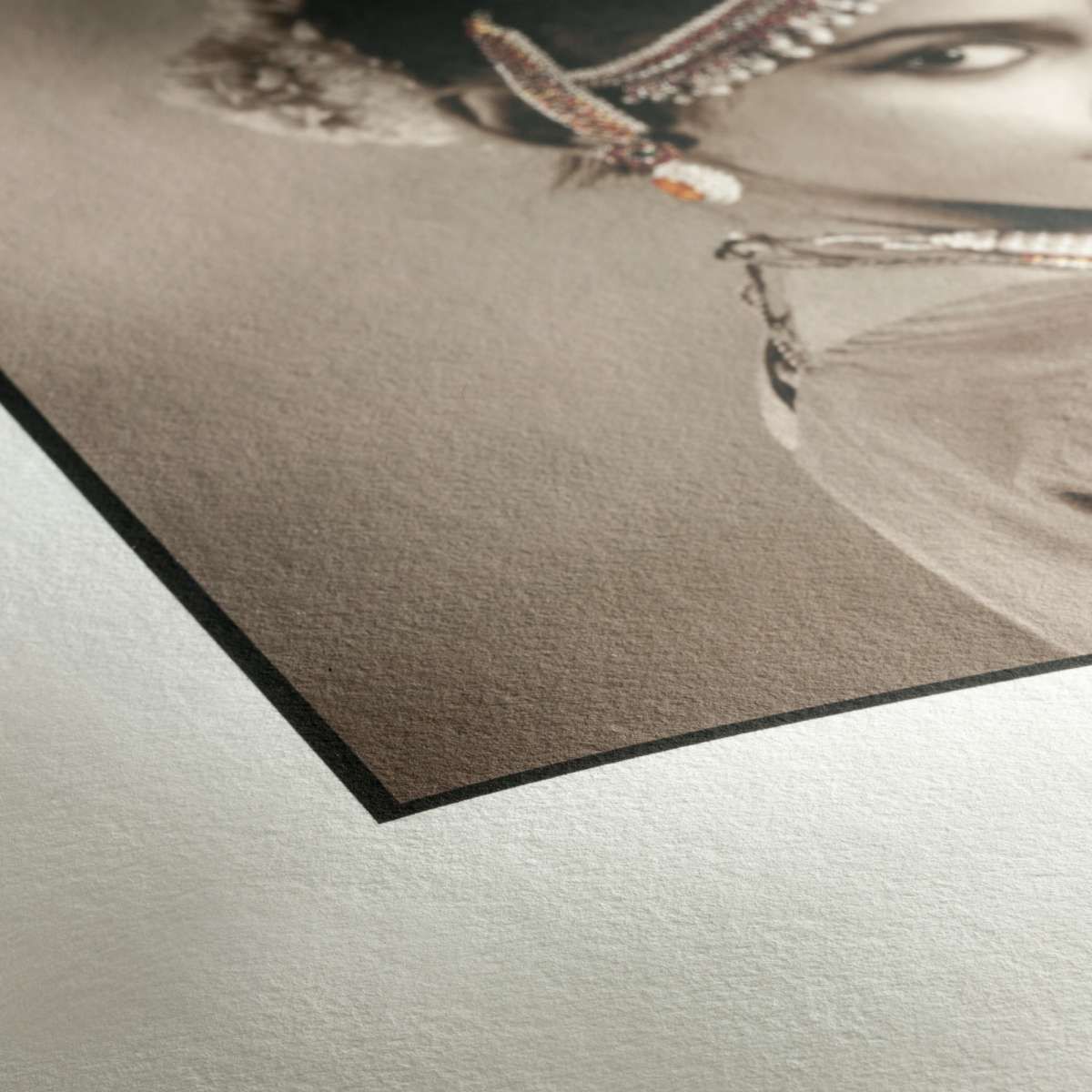 Close-up of a fine art print showing an Indian classical dancer, printed on premium matte paper with black backing.