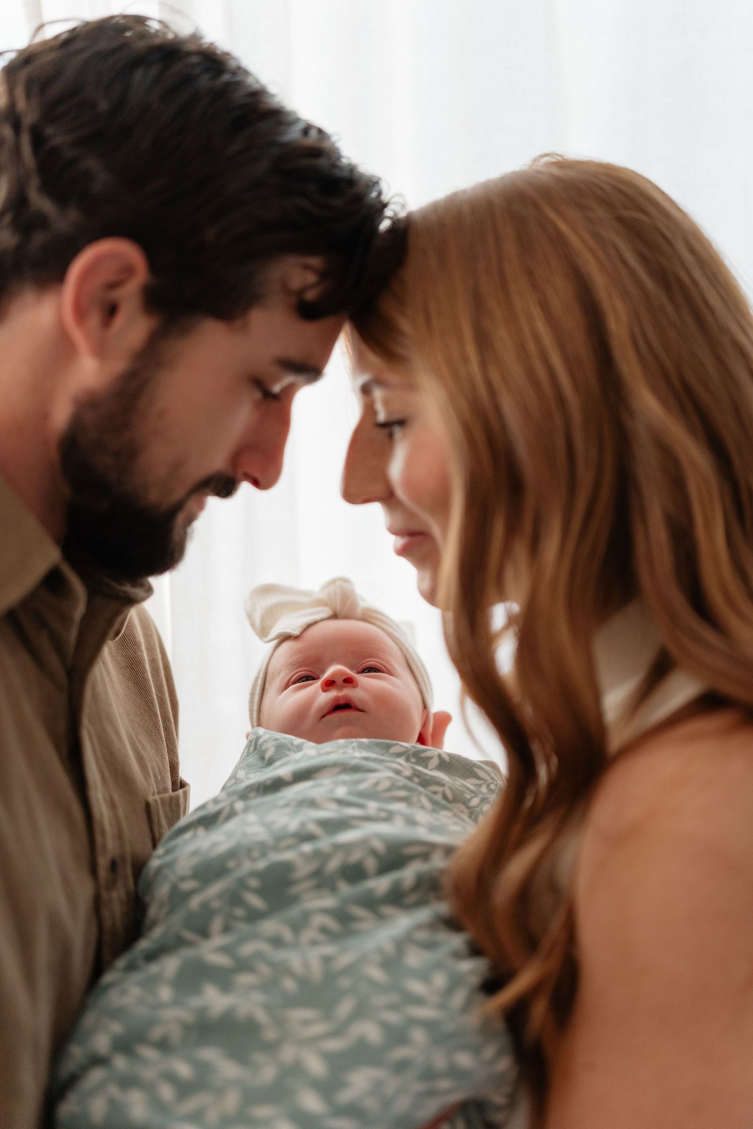 A series of intimate moments between a couple and their newborn baby, showing tender interactions and bonding.