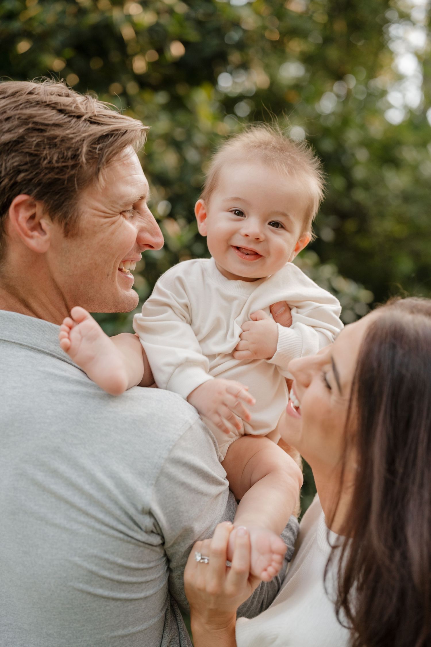 A family shares joyful moments together outdoors in a series of candid photos with natural lighting and greenery.