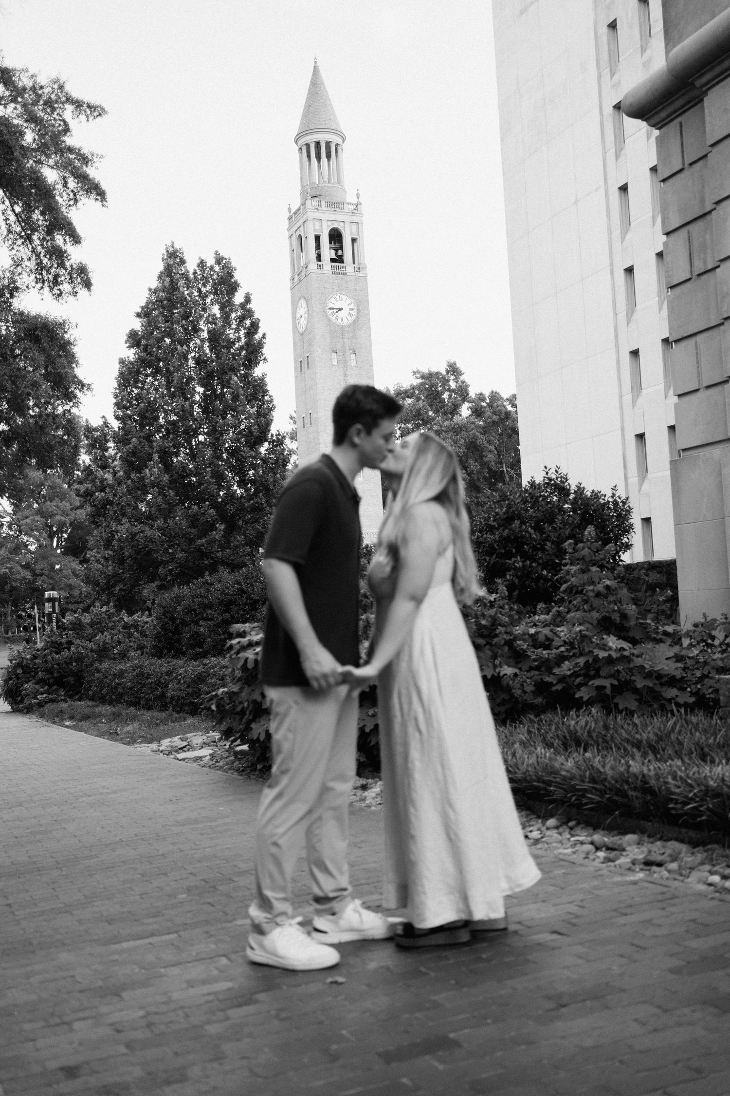A sequence of dance positions between two dancers shown in black and white photographs near a church building.
