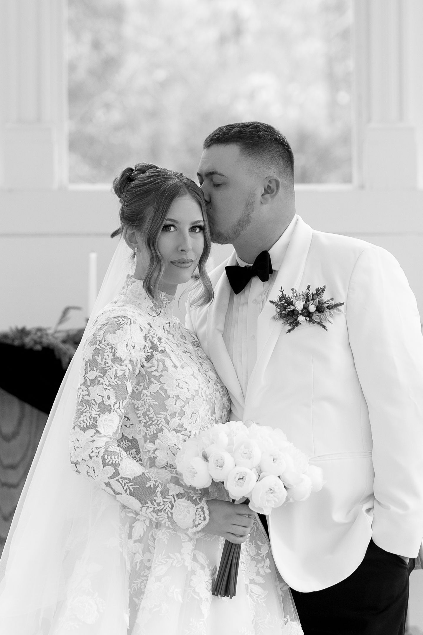 A romantic black and white wedding photo collage showing tender moments between a bride in lace and groom in white.