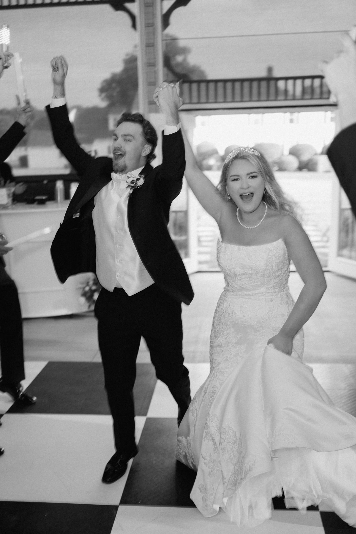 Black and white photo series of a wedding couple dancing energetically and joyfully at their reception party.