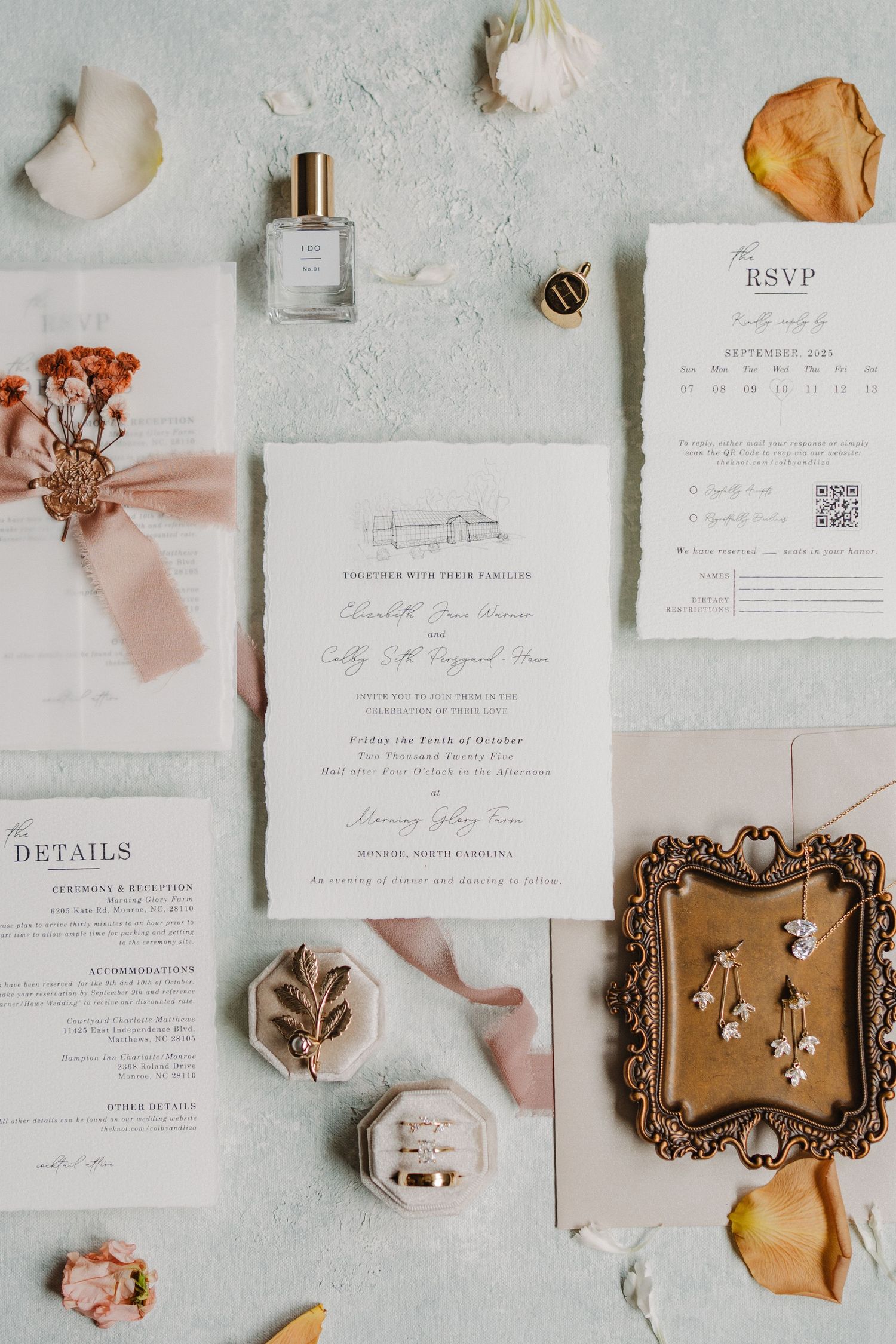 Elegant wedding invitation suite with white stationery, vintage gold frames, and dried flowers laid flat on light gray surface.