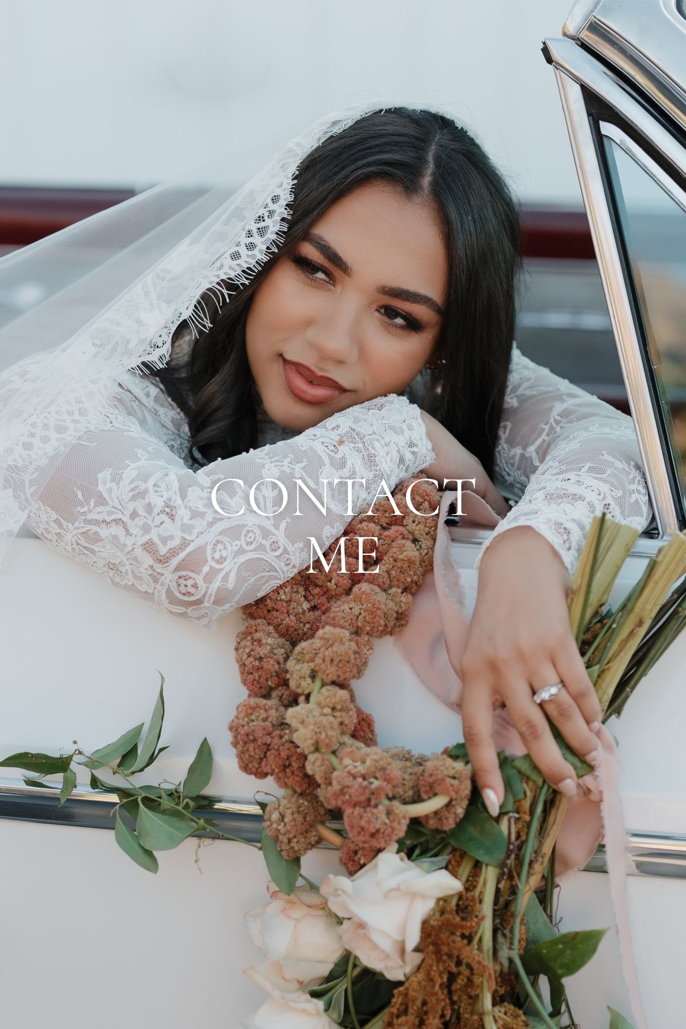 A person in a wedding dress poses with a bouquet in a vintage car for romantic bridal photos.