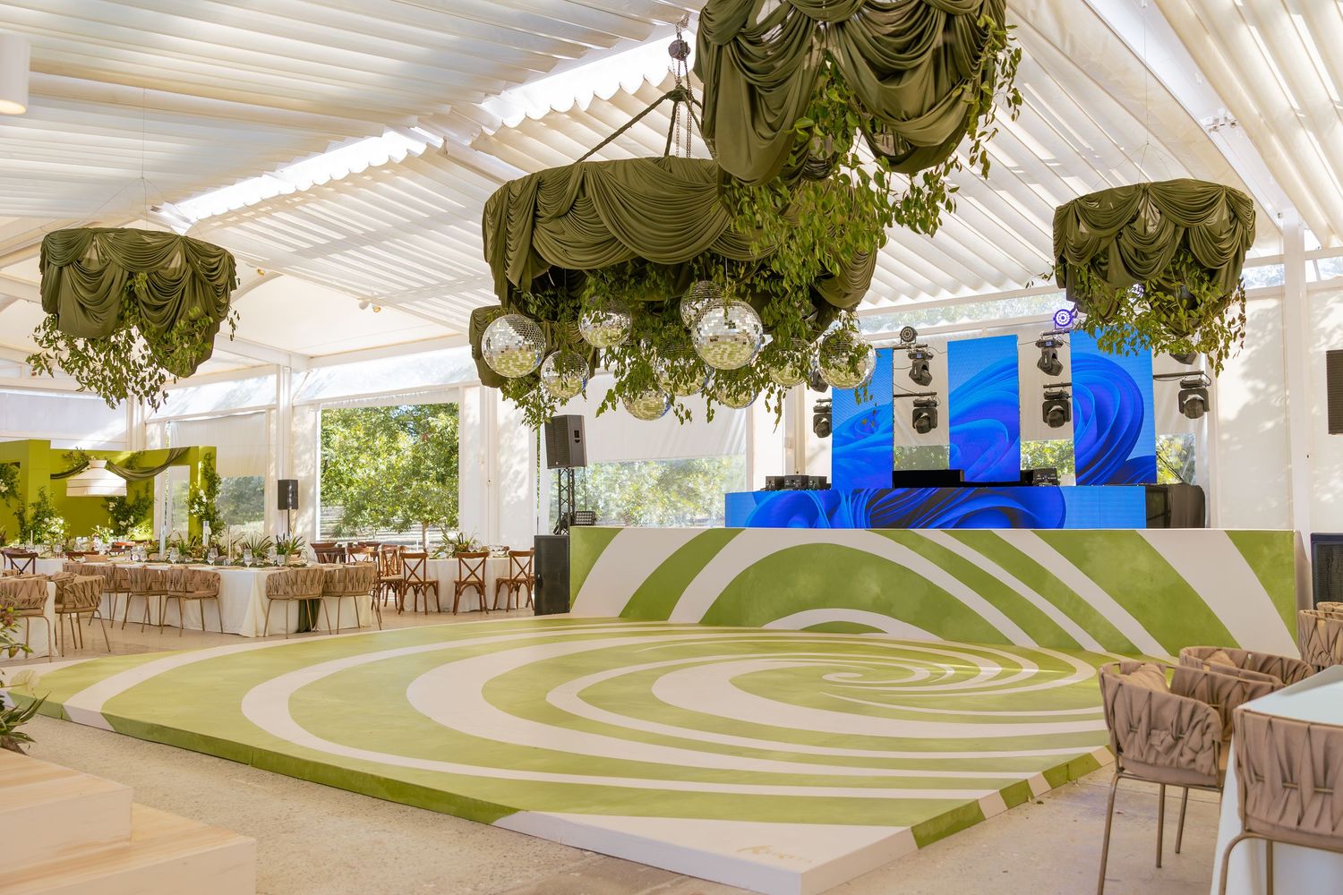Modern indoor bocce ball court with white walls and hanging plants in an upscale venue setting.