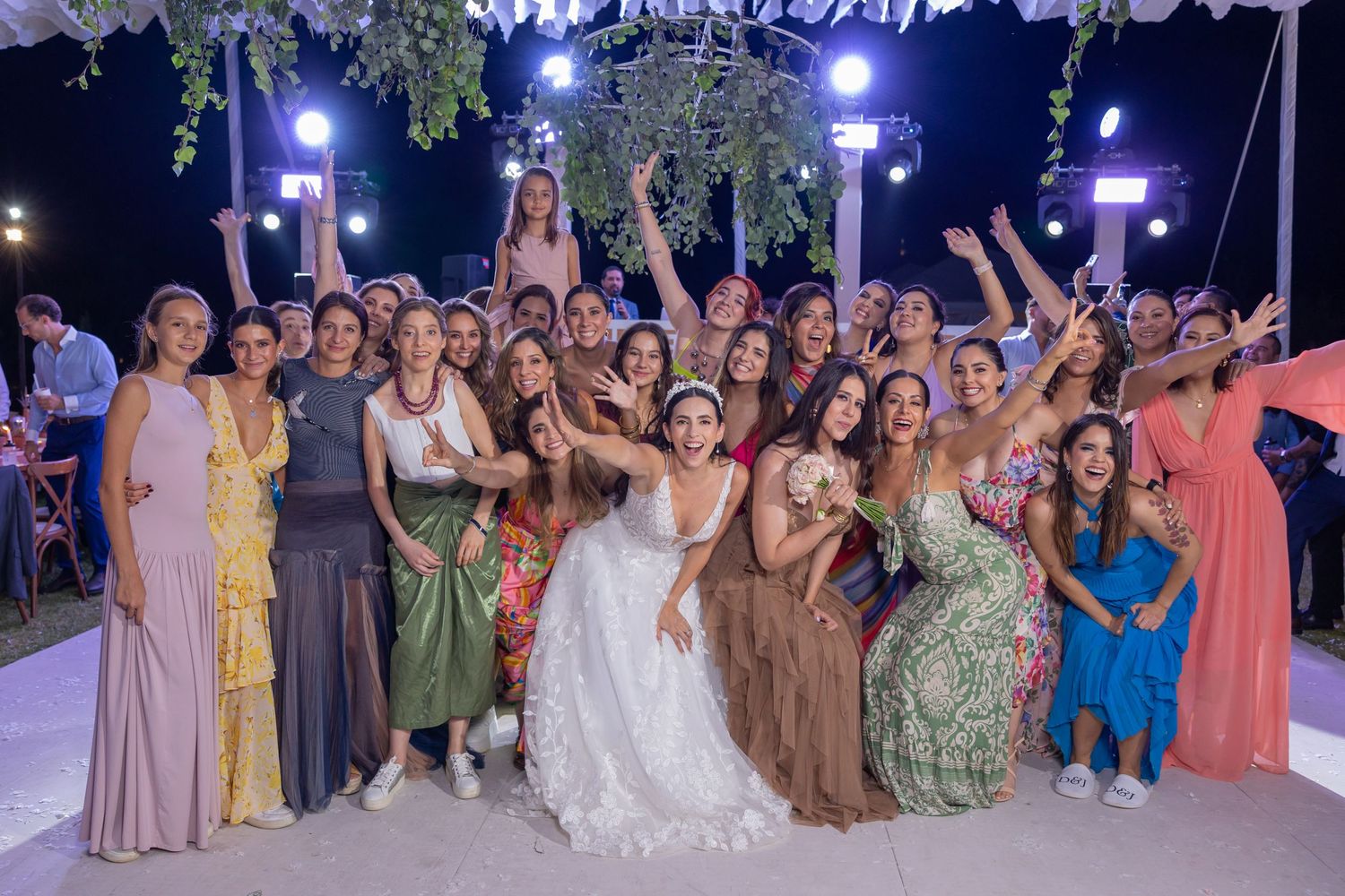 Celebration of a wedding with guests in colorful formal attire gathered on a decorated outdoor dance floor. Boda en Parras Coahuila fotógraf