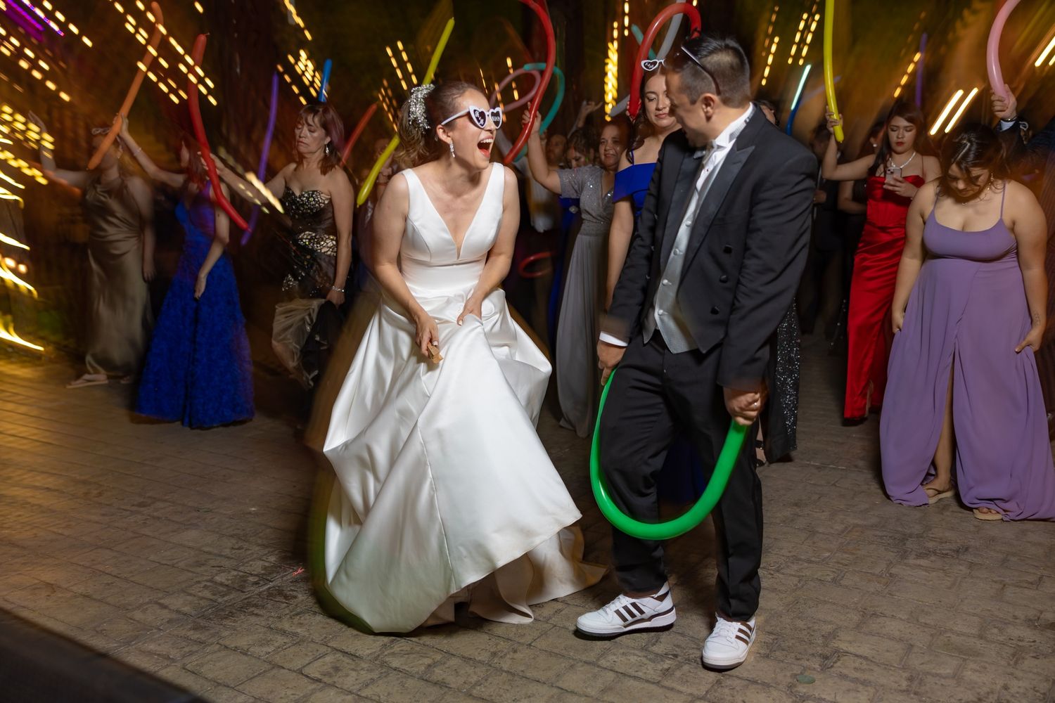 A fun wedding reception dance moment with a glowing neon light tube on the dance floor. Boda en Parras Coahuila fotógrafo