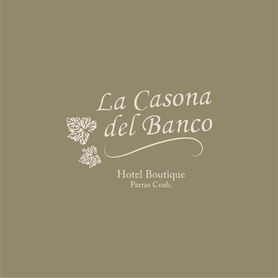 Boutique hotel logo for La Casona del Banco with elegant script and floral accents.
