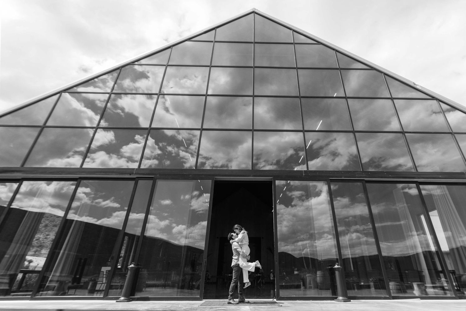 Modern glass pyramid structure photographed from multiple angles against cloudy sky and architectural surroundings.