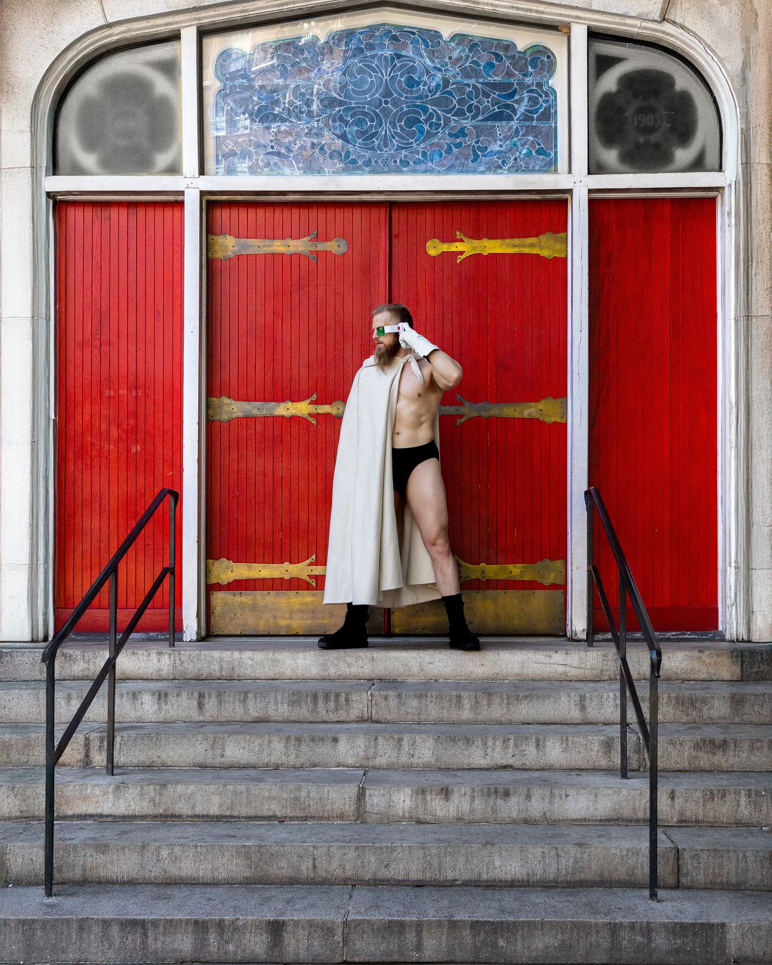 A sequence of four connected images shows someone moving across windows with red curtains on a building exterior.