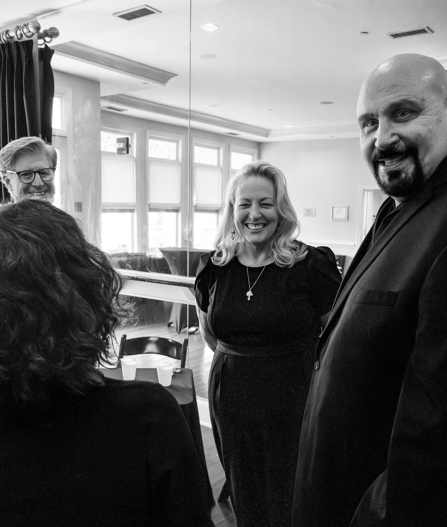 Black and white candid shots show two people sharing joyful moments and laughter together.