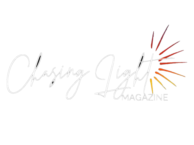 Chasing Light Magazine logo with elegant script font and a sunburst graphic in red, orange, and yellow tones.