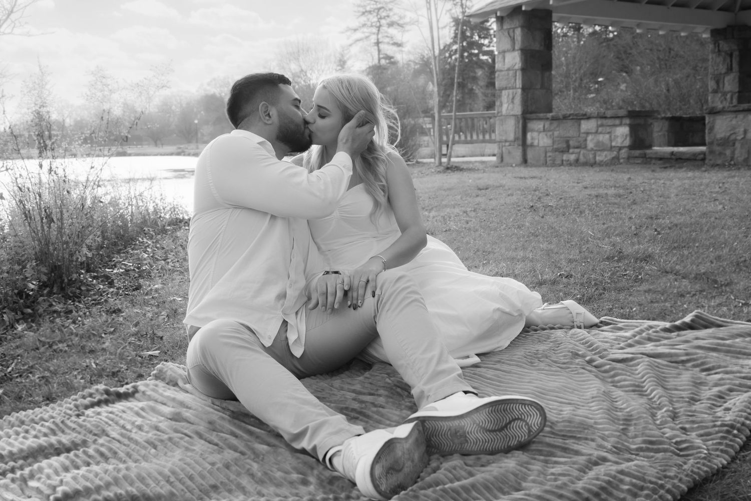 A series of black and white romantic photographs showing a couple sharing tender moments together in outdoor settings.