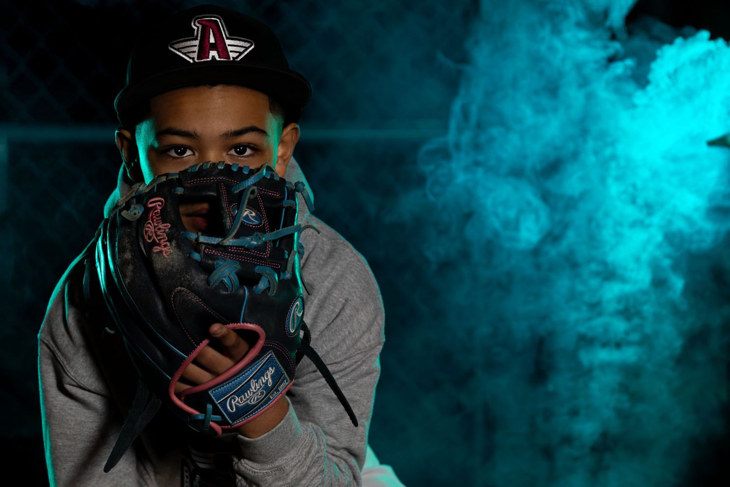 Person in protective mask against dramatic blue smoke background.