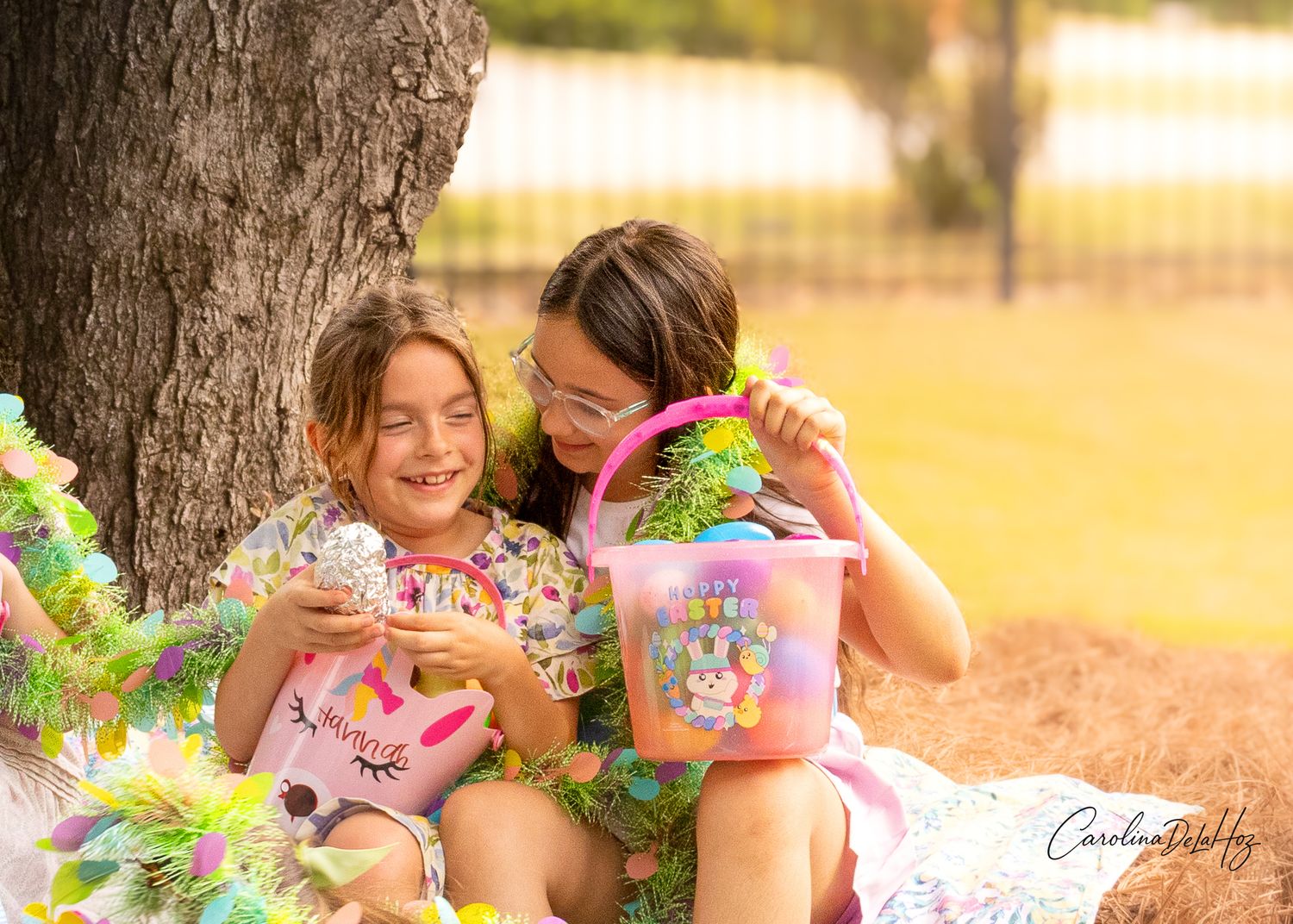 Two people sharing sweets and snacks while having a picnic under a tree on a sunny afternoon.