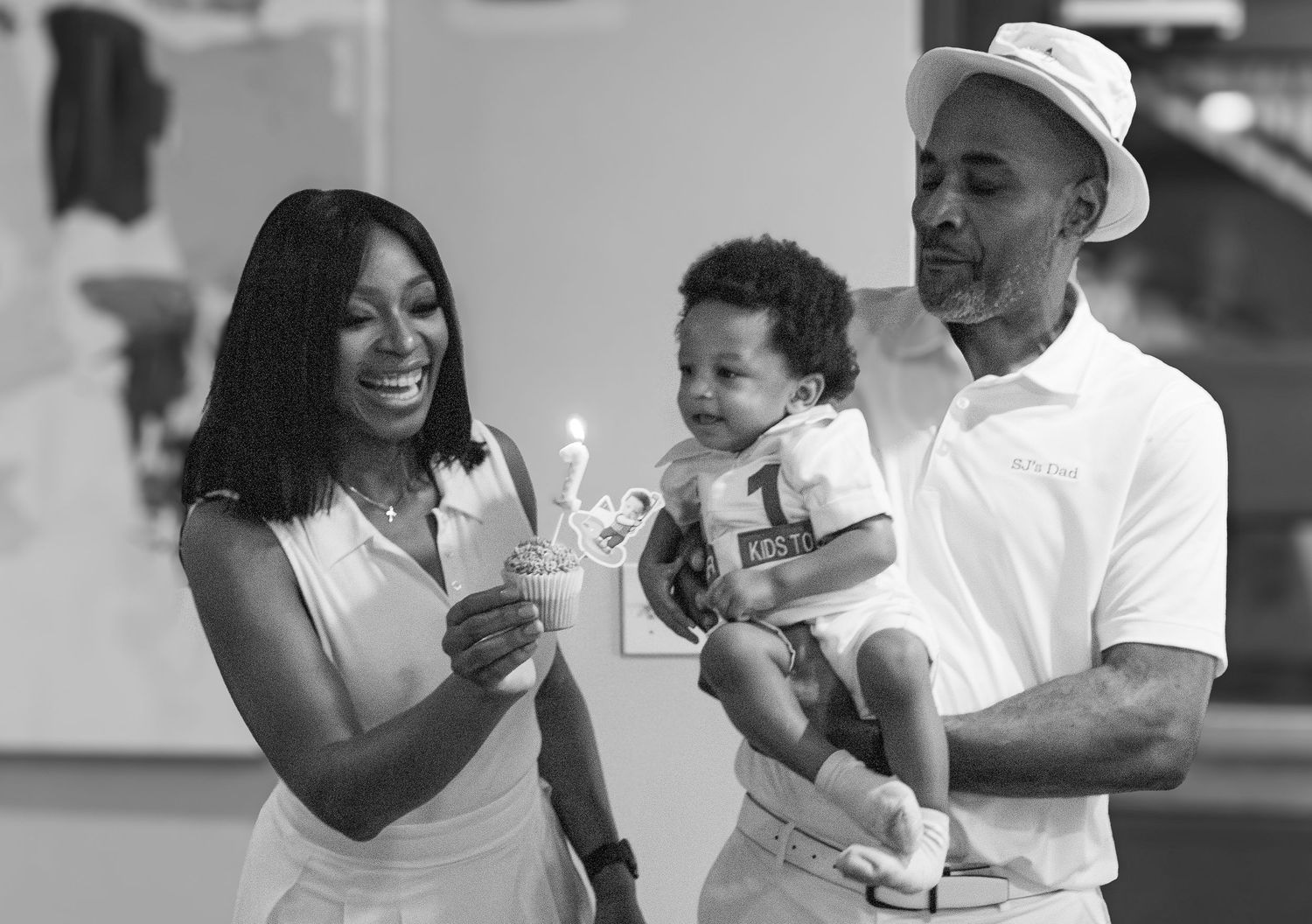 A series of black and white photos showing joyful moments between family members at home.
