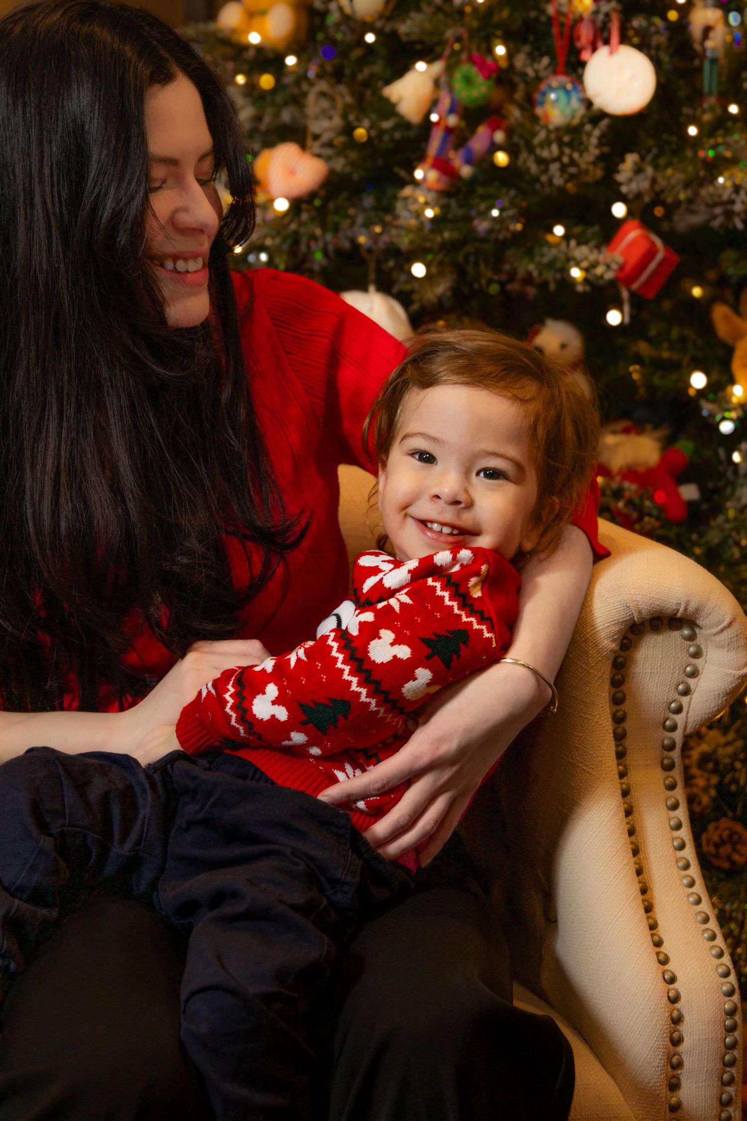 A series of holiday photos showing a festive moment on a beige couch with Christmas tree lights twinkling in background.