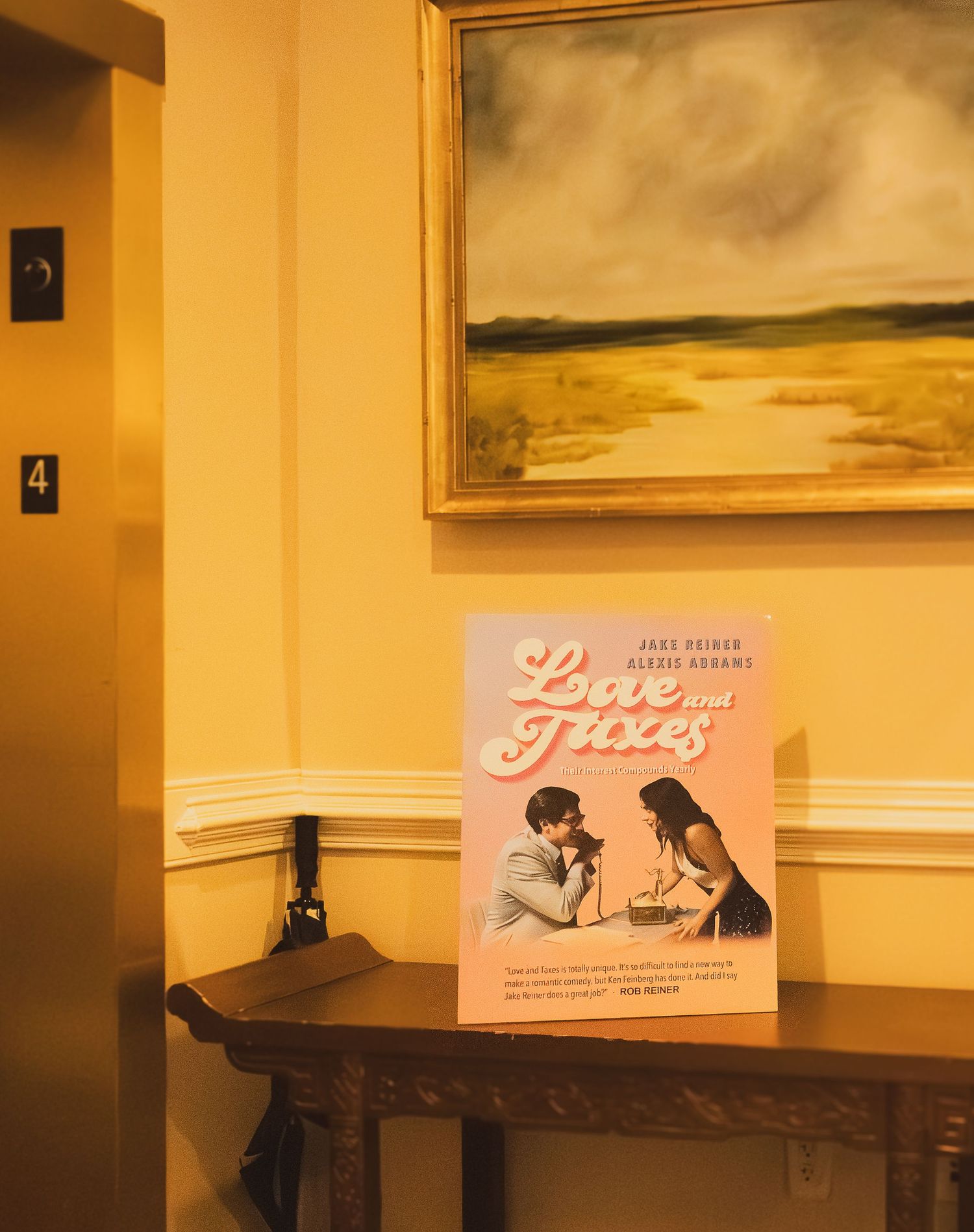 A series of vintage film posters or promotional materials displayed on a beige wall in warm lighting.