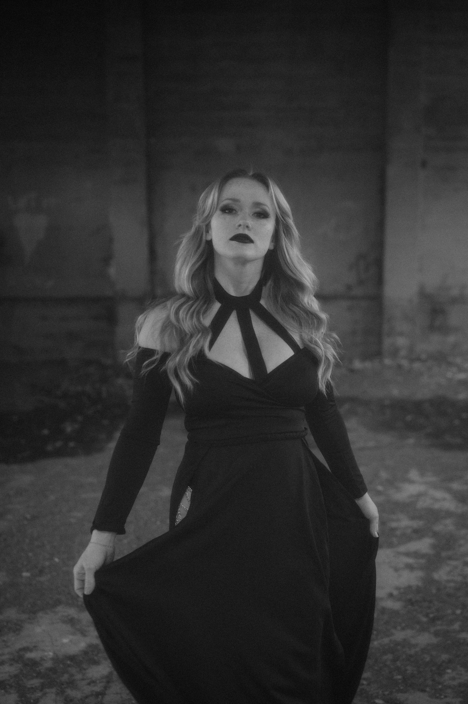A series of moody black and white fashion portraits of a person in dark clothing against a textured background.