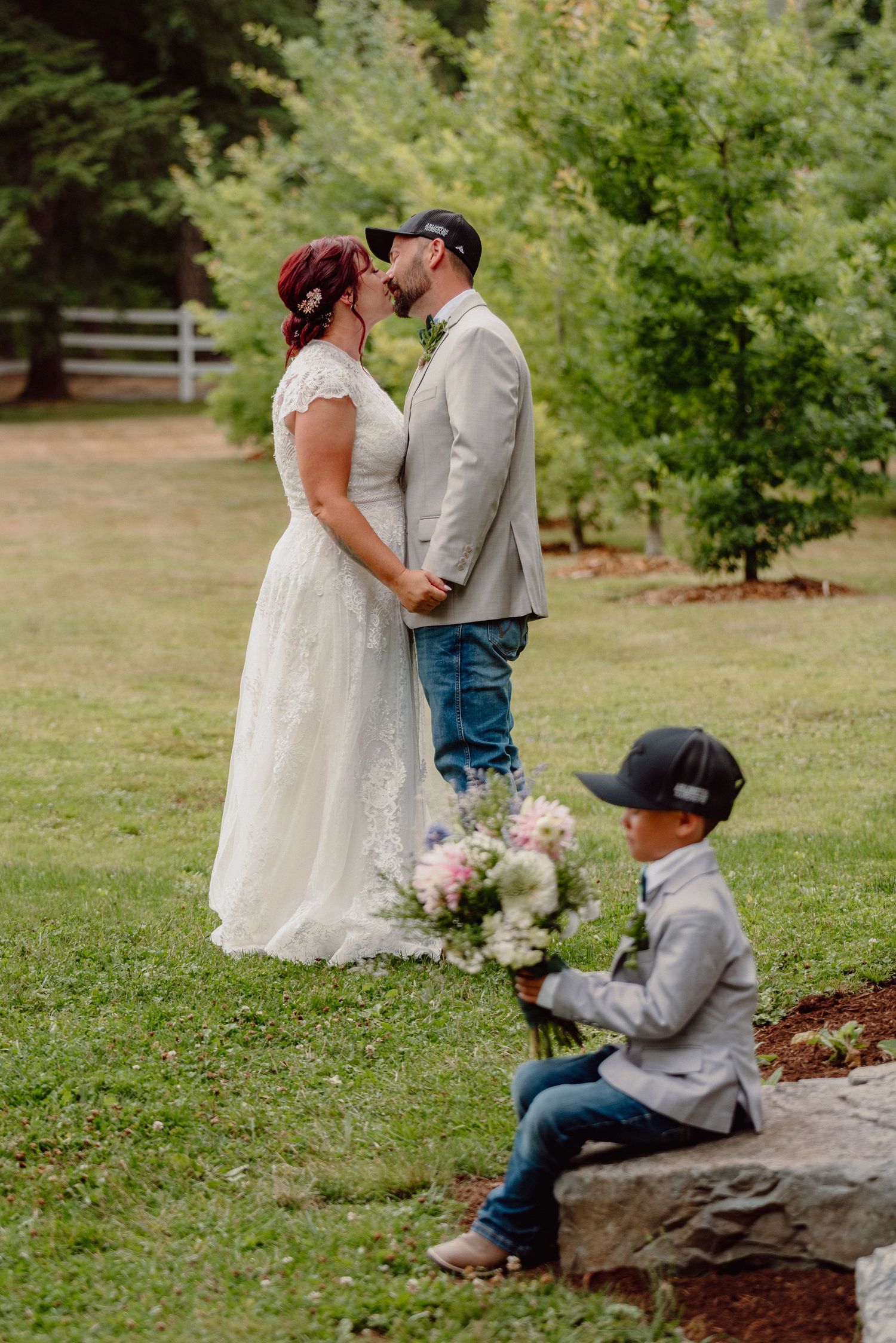 An intimate wedding moment captured in a garden setting with natural greenery.