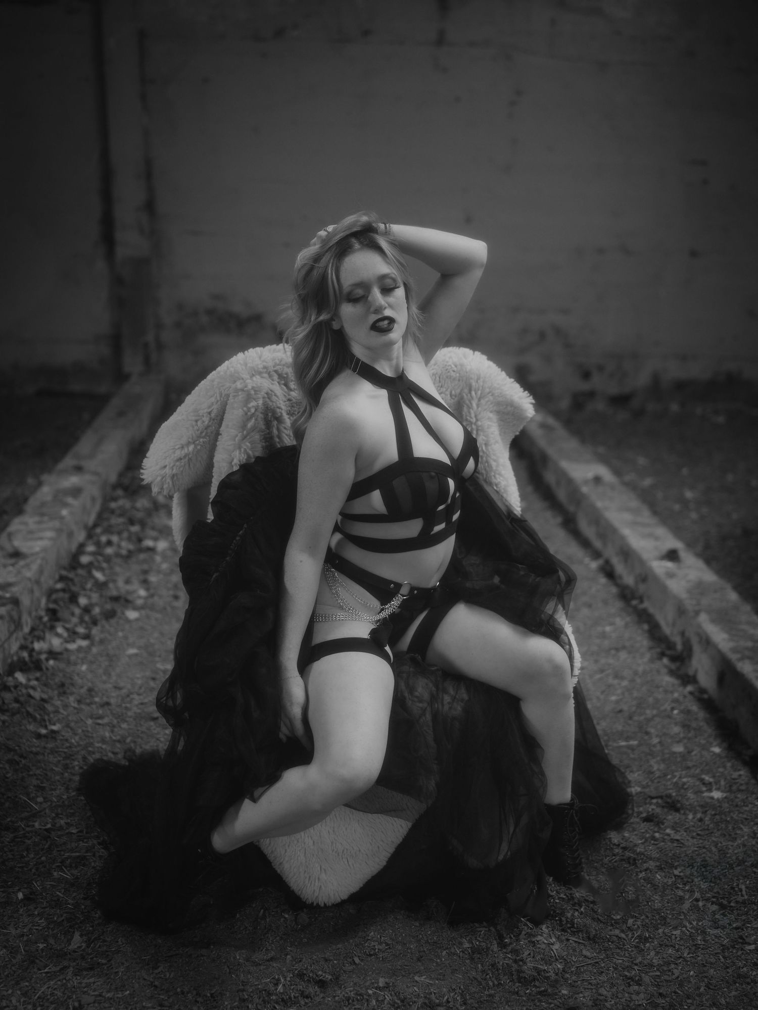 Black and white artistic photo series showing a vintage-inspired burlesque performance on railroad tracks.