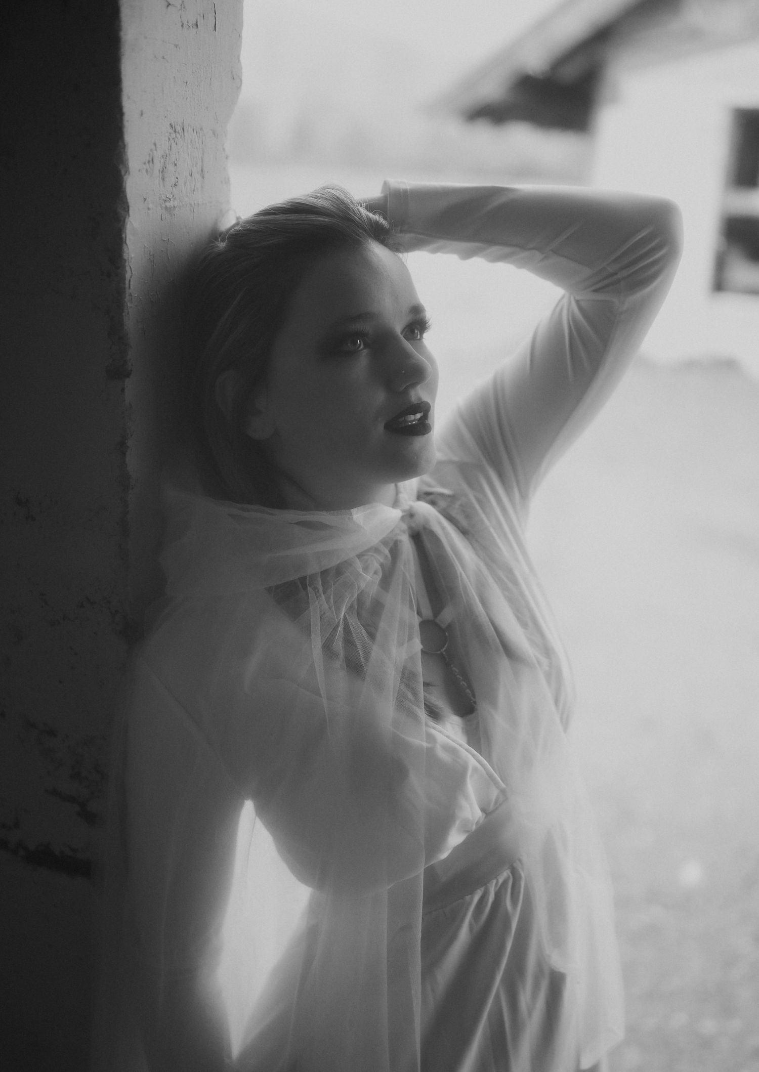 A series of ethereal black and white photos showing graceful dance-like movements against a light background.