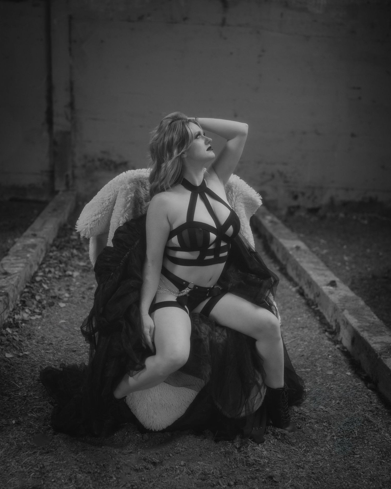 A moody black and white photo series showing a person lying on train tracks in dark artistic poses.