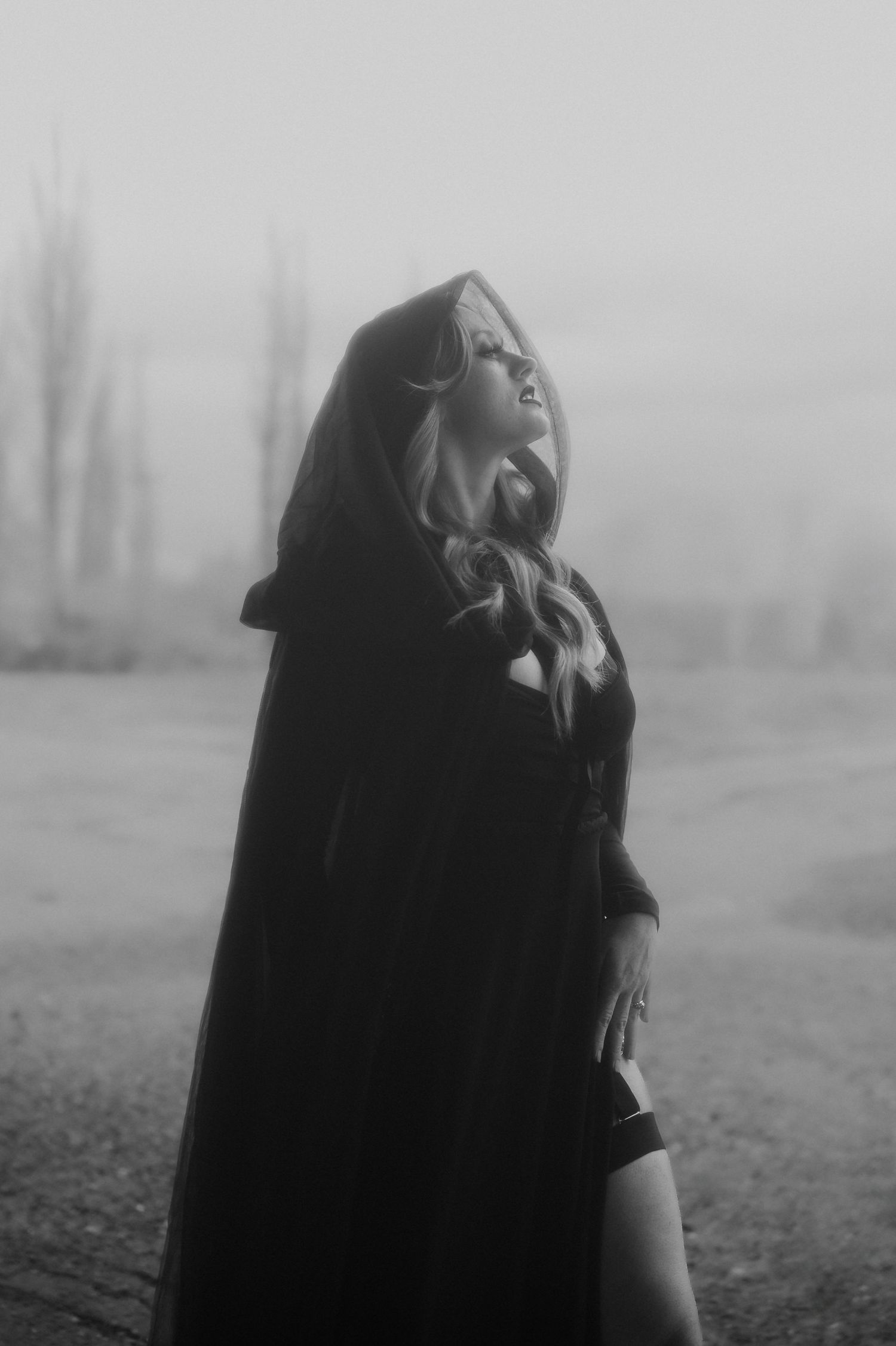 A moody black and white photo series showing a figure in a dark coat on a misty day looking upward.