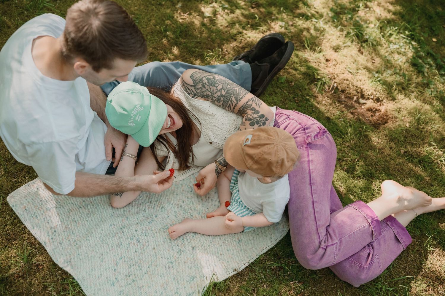 Close-up of couple painting and decorating together during an outdoor crafts activity on a sunny day.