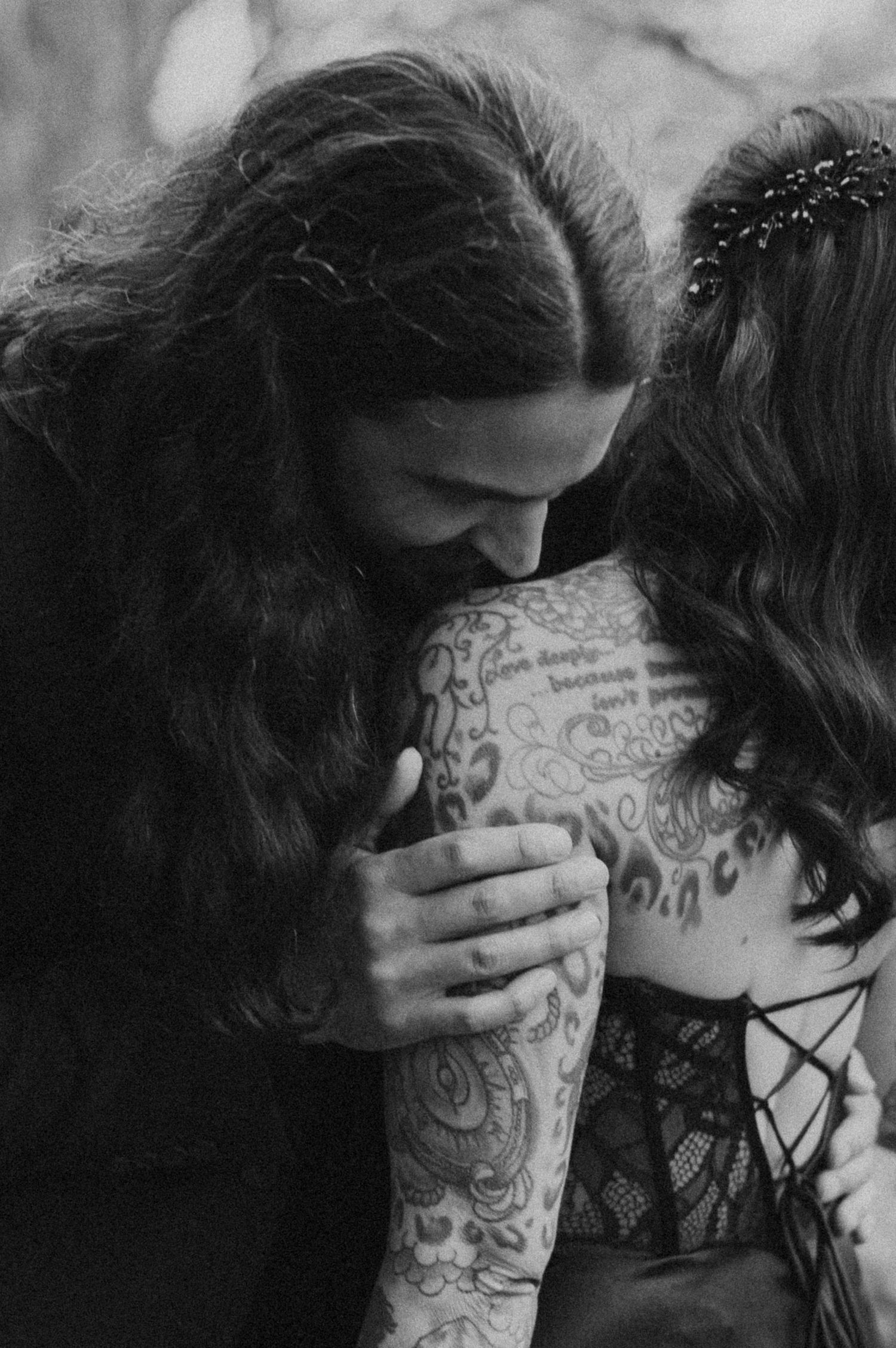 A black and white photo sequence shows two people embracing intimately with one person having visible tattoos.