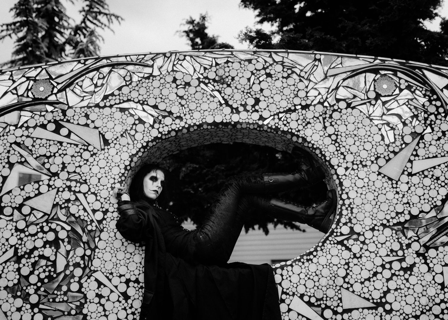 Black and white artistic photo series showing a figure among blooming cherry blossom branches in winter.