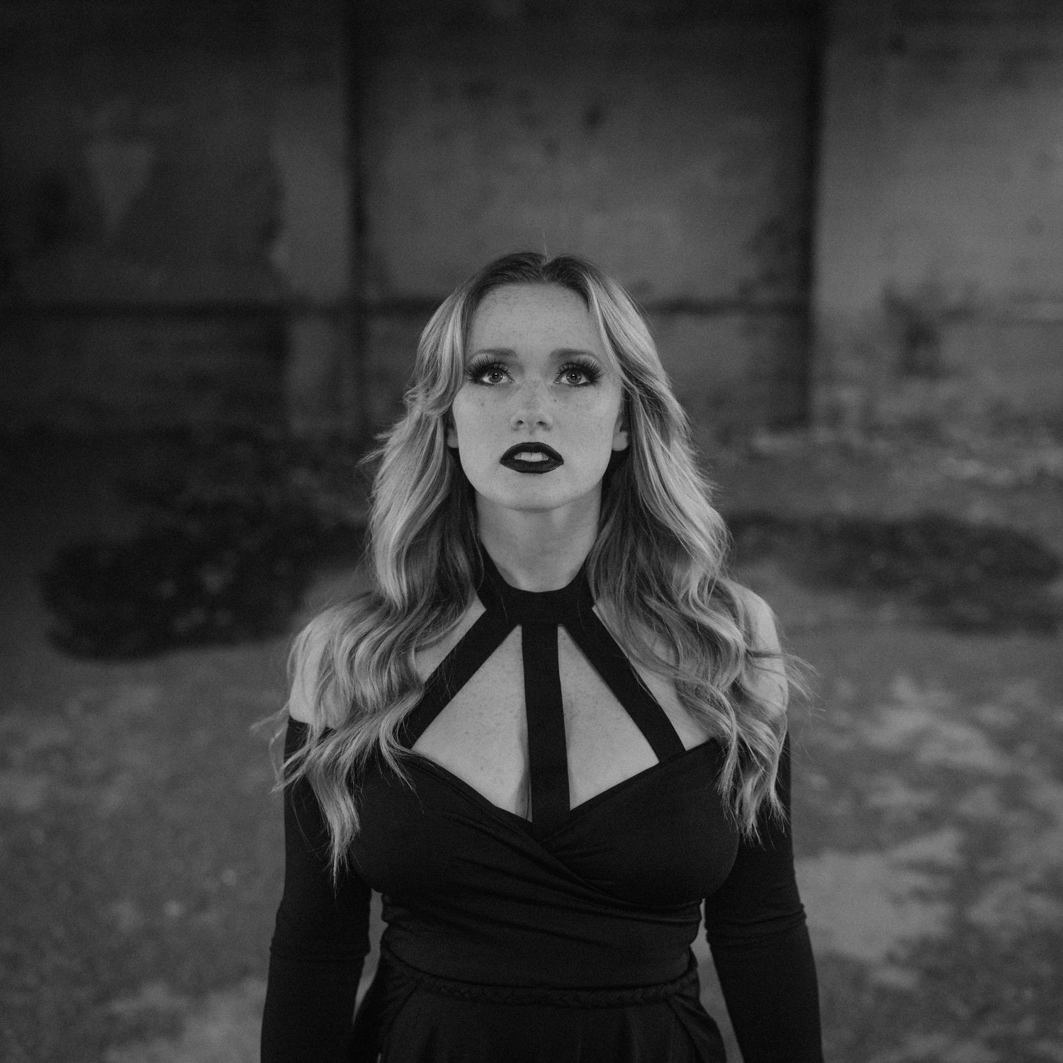 A dramatic black and white artistic photo series showing different dramatic portrait angles against a dark background.