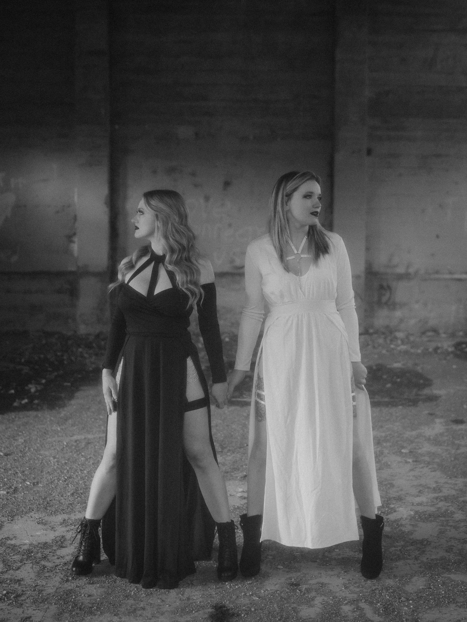 Side-by-side black and white photos showing contrasting figures in black and white clothing against a stark background.