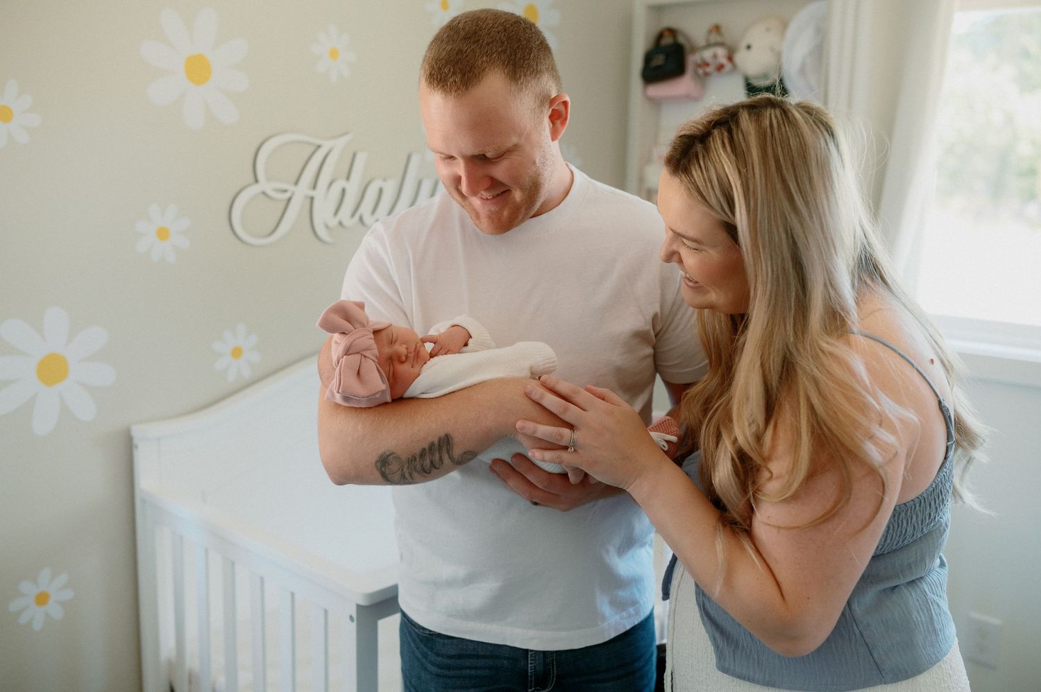 A couple shares intimate embraces and laughter during a bright indoor photo session at home.