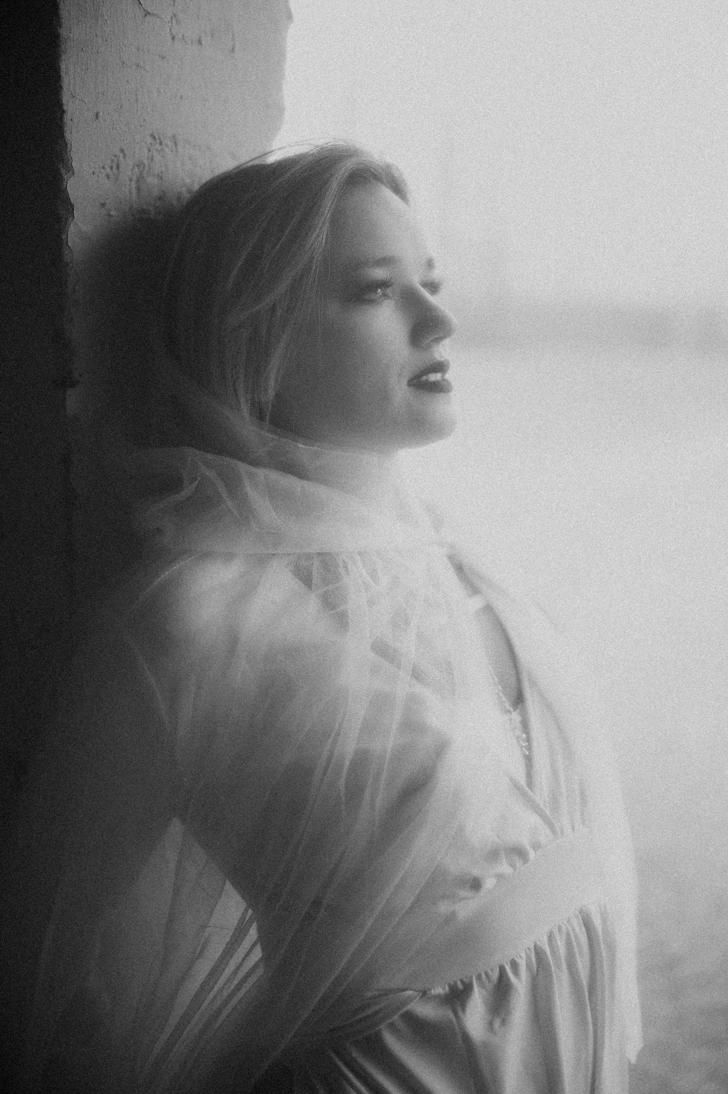 A dreamy black and white photo sequence showing movement with a flowing white dress and ethereal double exposure effect.