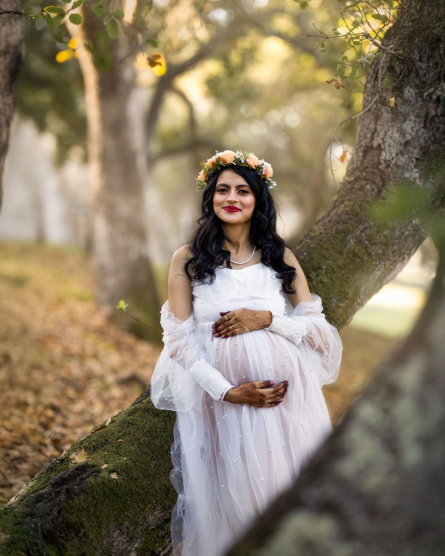A dreamy portrait series in a forest setting with soft golden light filtering through trees, featuring ethereal white clothing.