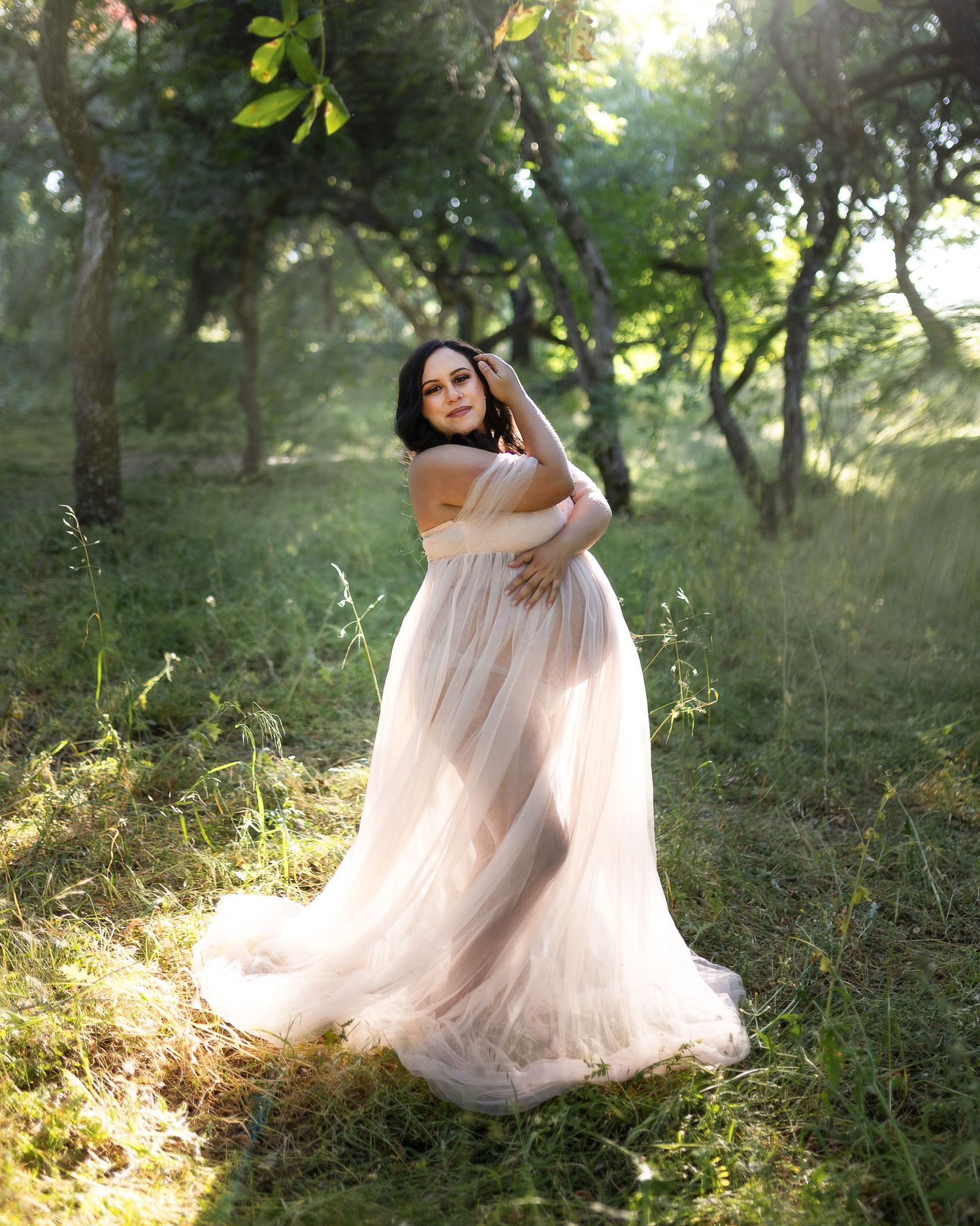Ethereal pink tulle dress flows gracefully through a sunlit forest setting creating a dreamy atmosphere.
