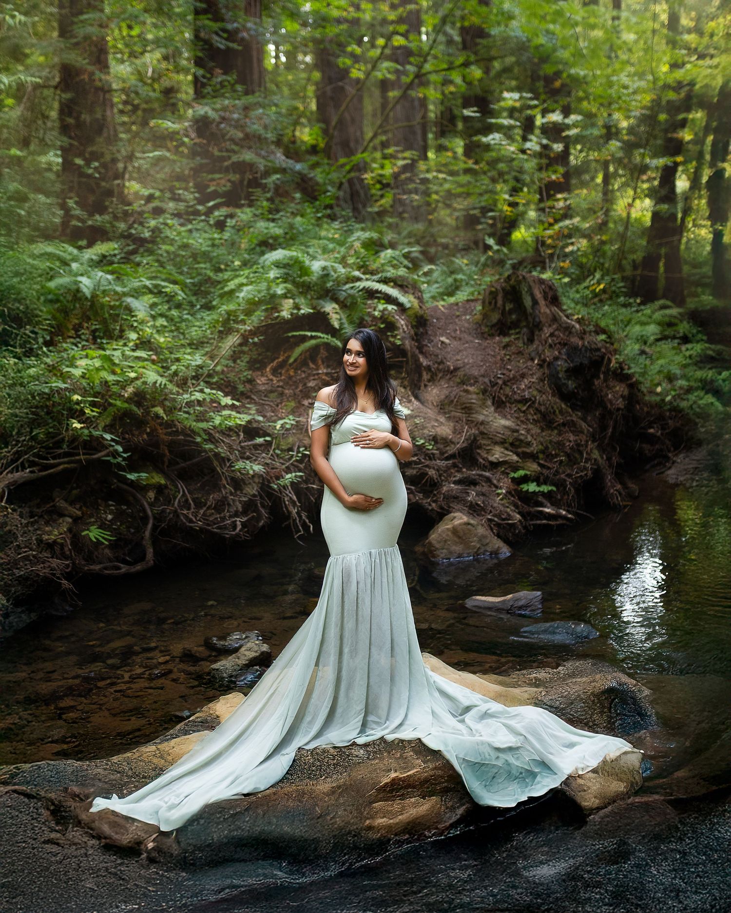 A figure in a flowing white dress poses gracefully on a mossy rock by a serene forest stream in multiple artistic shots.