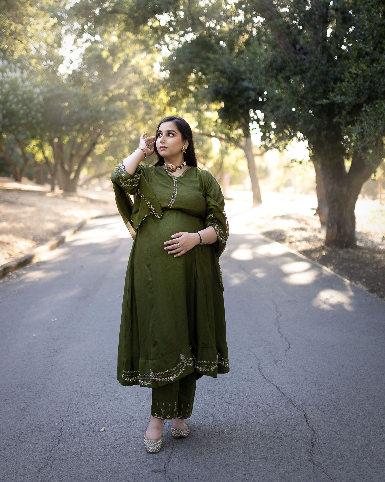 A series of photos showing someone modeling an olive green dress with lace trim details in an outdoor setting at sunset.