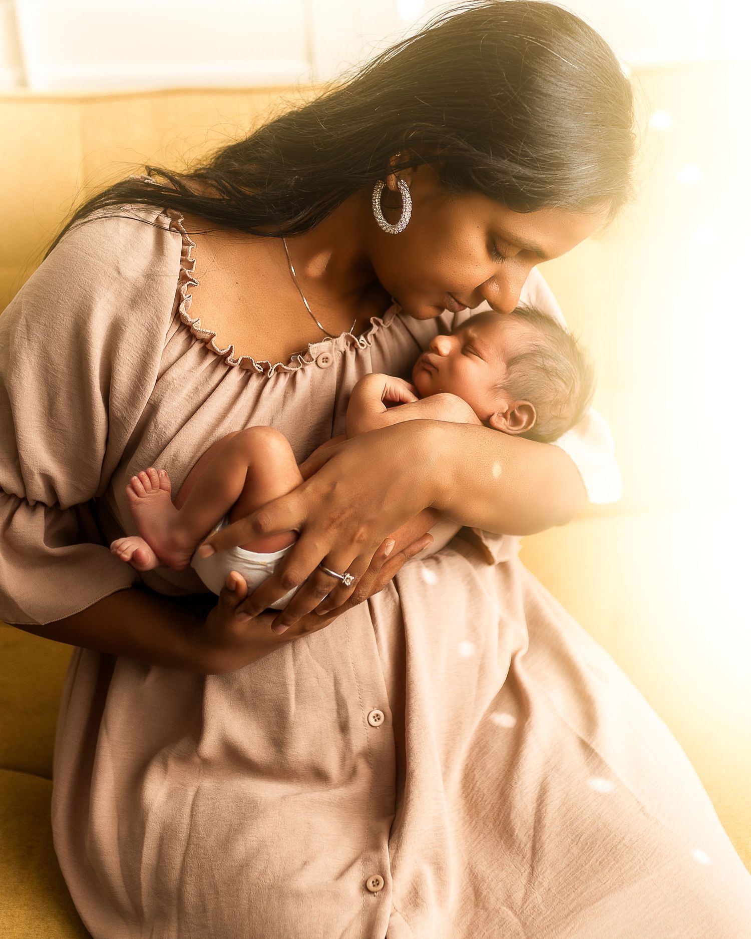 A tender moment between parent and baby captured in warm sepia tones across multiple intimate poses.