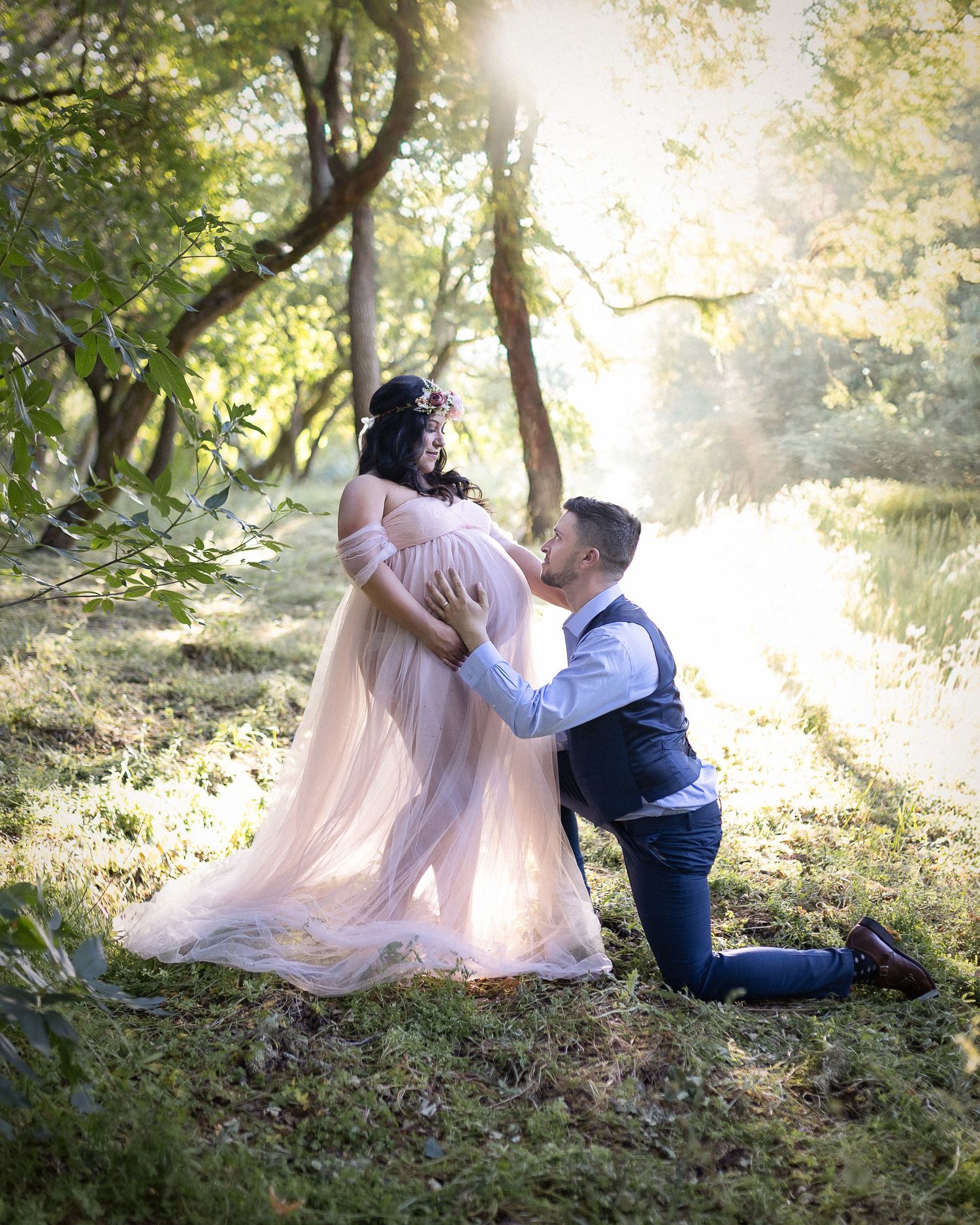 A romantic scene in a sunlit forest with a flowing pink dress and classic formal attire.