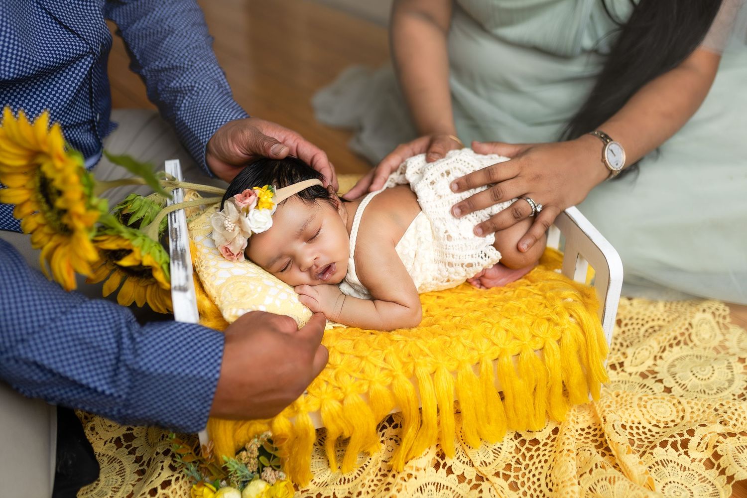 People preparing sunflower heads for cooking by removing seeds in a kitchen setting.