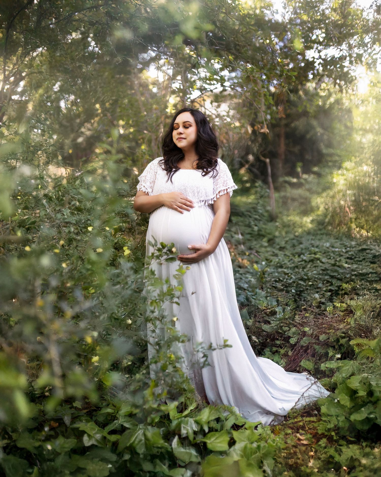 A dreamy outdoor photoshoot in a lush garden setting with soft natural lighting filtering through the foliage.
